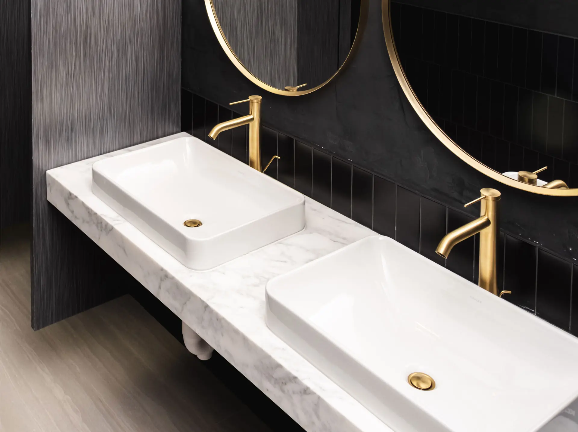 Twin bathroom sinks with brass faucets and fittings